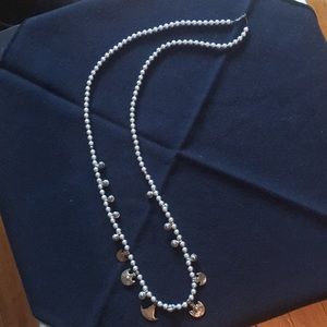 Silver bead necklace with brass charms